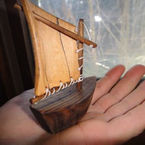 tiny sailboat held in someone's palm